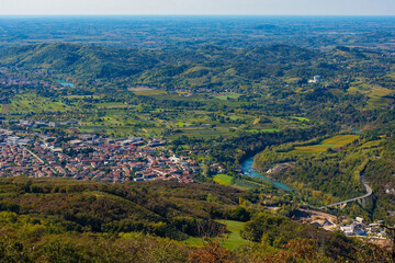 Obraz premium The western Slovenian city of Nova Gorica viewed from the slopes of Mount Skabrije. The Soca River is on the right with the historic Solkan Bridge in the foreground 