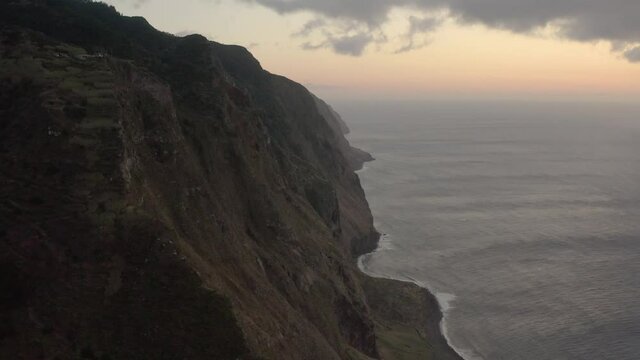Aerial flying sideways showing beautiful coast after sunset in Ponta da Ladeira, Madeira