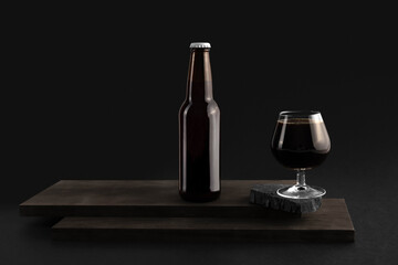 Beer bottle on a wooden block with glass on the black background, craft beer mockup templates, with empty space to place your label or design