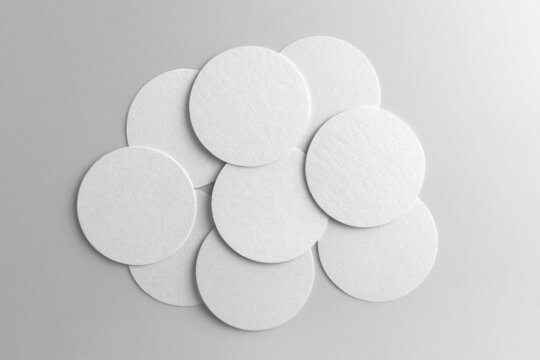 Blank circle beer pad mockups in a stack, white background, craft beer mockup templates, with empty space to place your label or design