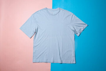 Blue t-shirt mockup on colorful background. Flat lay tee template