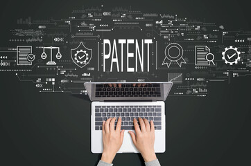Patent concept with person using a laptop computer