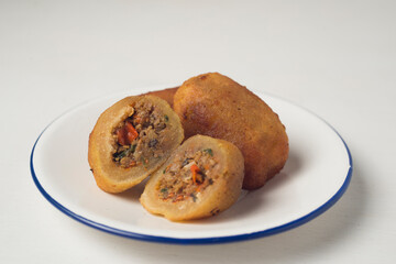 Combro, popular street food originally from West Java. Combro is an abbreviation from Oncom di jero which means there's oncom inside. Combro is a snacks made from cassava root filled with spicy oncom.