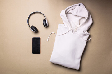 Mockup of a folded white pullover hoodie with man accessories  - obrazy, fototapety, plakaty