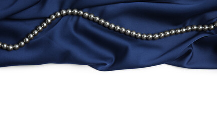 Beautiful pearls and dark blue silk on white background