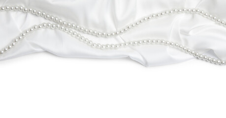 Beautiful pearls and delicate silk on white background