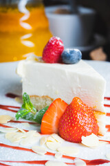 Piece of classic cheesecake with strawberries on a plate