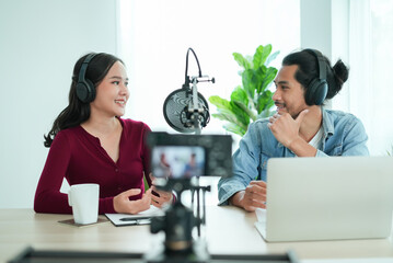 content creator occupation concept. Two influencer record podcast audio in-home office by a...