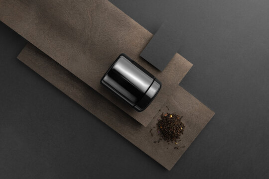 Blank Tea Black Container Packaging, With Business Card On Black Background With Wooden Elements, Packaging Mockup With Empty Space To Display Your Branding Design.