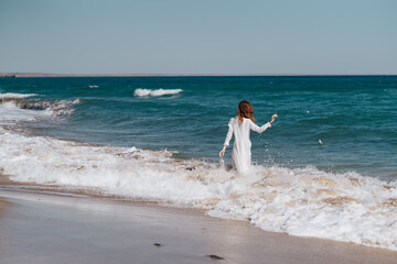 Woman in white dress near the ocean walk fresh air landscape