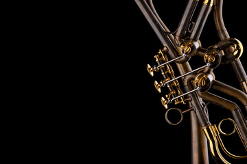 A rotary type trumpet with a curved leadpipe in matte brown with gold elements on a black background