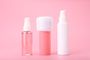 Trendy modern composition with a set of beauty products in a row against on  pink background. Concept of daily anti acne or regular skin care routine for healthy, young looking skin