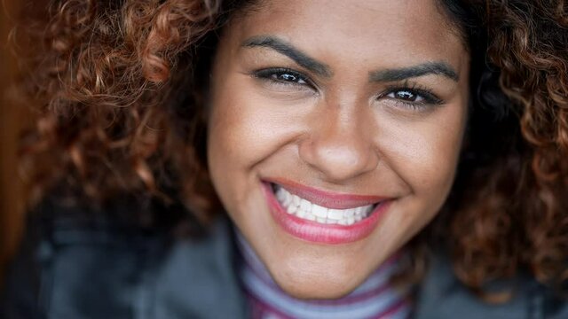 Hispanic black woman smiling at camera portrair close-up face. Brazilian person smile