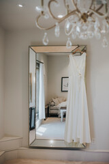 Fototapeta na wymiar wedding dress hanging from mirror