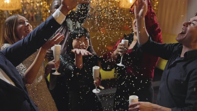 High Angle Shot of a Group of Friends Celebrating New Years Eve with Confetti