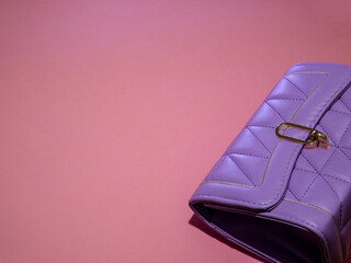 one purple women's leather bag with pink background