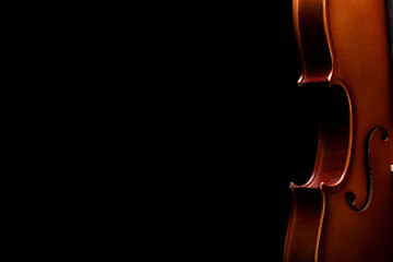 Part of a violin or viola on a black background