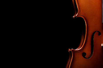 Part of a violin or viola on a black background - obrazy, fototapety, plakaty
