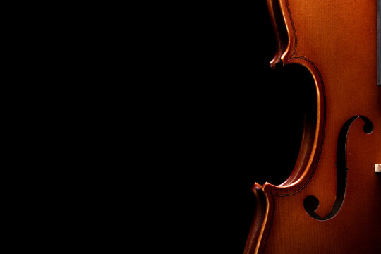 Part of a violin or viola on a black background