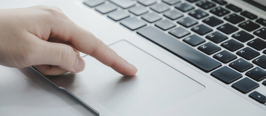 Authentication. close up hand touching touchpad on laptop computer at office, work from home, searching web, social network, online, business strategy, finance, investment, digital technology concept