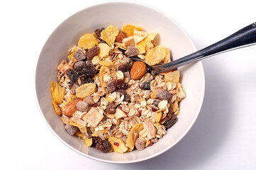 Oat flakes for breakfast in a bowl with spoon