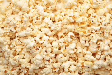 Scattered salted popcorn, texture background. Top view.