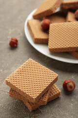 Chocolate wafers on brown background with hazelnut. Vertical photo.