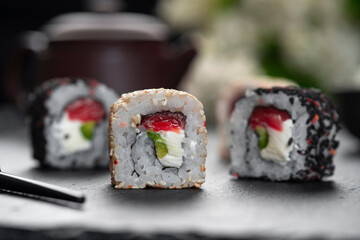 Roll with fish sushi with chopsticks. Chess Roll . Japanese kitchen, restaurant.