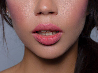 Fototapeta premium Close-up perfect lip makeup beautiful female mouth. Plump sexy full lips. Macro photo face detail. Perfect clean skin, fresh lip make-up. Sweet pink lipstick, magenta color. Valentine's day style