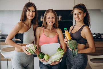 Group of fit girls at with vegetables
