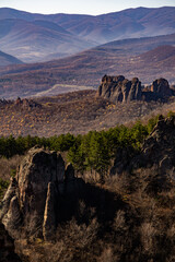 A beautiful rocky - mountain landscape in Belogradchik Bulgaria. 
A castle door looking rock in the background.
