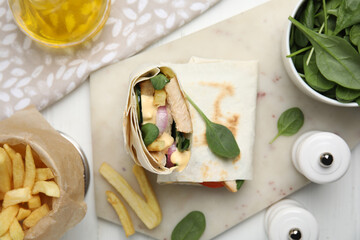 Delicious shawarma with chicken and fresh vegetables served on white wooden table, flat lay