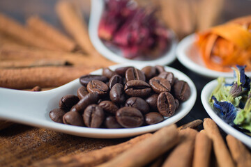 Coffee bean in close up and other beverage ingredients such as, butterfly pea flower, cinnamon, hibiscus tea from roselle flower and sappanwood tree tea
