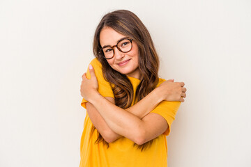 Young caucasian woman isolated on white background hugs, smiling carefree and happy.