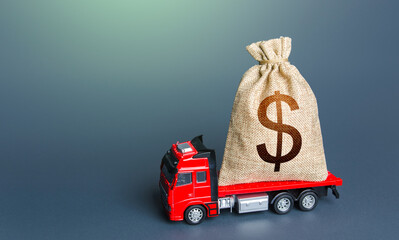 Truck with a dollar money bag. Loan or deposit. Financial aid, investments and subsidies....