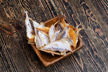 Fototapeta na wymiar dried and butchered small fish on a wooden table