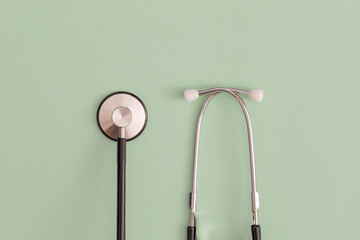 Stethoscope on green background. Top view. Flat lay. Medicine concept.