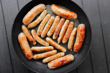 lots of delicious fried sausages in the pan 