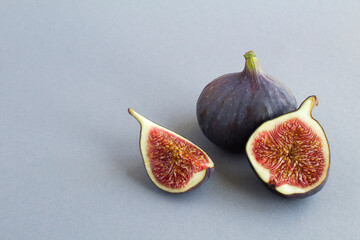 Close-up on ripe blue figs on the gray background. Copy space.
