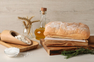 Composition with fresh crispy ciabatta on white wooden table
