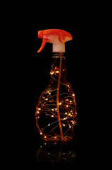 atomizer or a spray bottle with lights on a black background