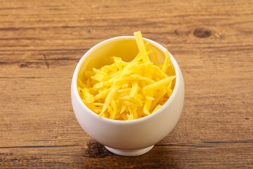 Shredded yellow cheese in the bowl