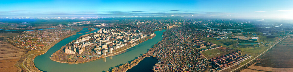 Naklejka premium the Yubileiny microdistrict of the city of Krasnodar on the bend of the Kuban River and the Adyghe coast - a large aerial panorama on a sunny day in late autumn