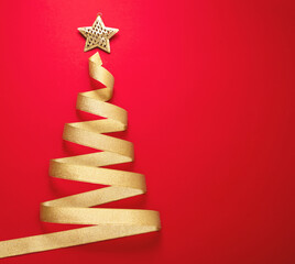 Christmas tree shape golden ribbon on red background. Shiny star on top. Merry Xmas card