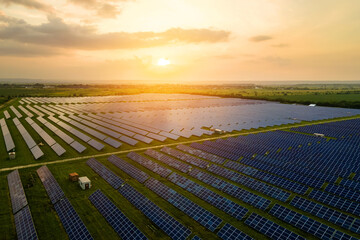 Aerial view of large sustainable electrical power plant with many rows of solar photovoltaic panels...