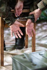 A guard unlocks the handcuffs of an accused soldier with a small key.