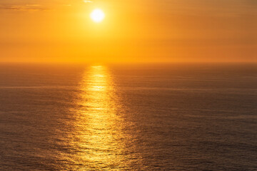 beautiful sunset on the calm sea surface as a natural background