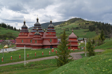 Fototapeta na wymiar Red church in The Volosianka village in Carpathian Mountains, Ukraine
