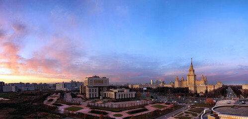 Wide angle aerial panorama of autumn campus of Moscow University under dramatic sunset cloudy sky