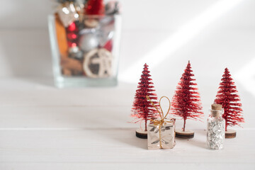 Christmas decorations, Christmas toys in a vase, and little red Christmas trees